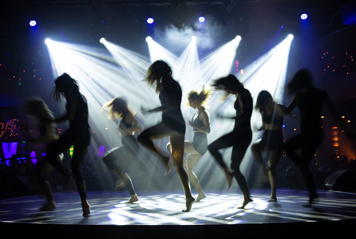 Stage show dancers in silhouette